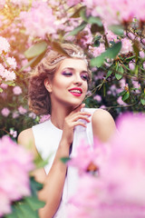 Obraz na płótnie Canvas girl in dress in rhododendron garden