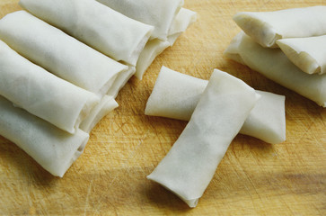 uncooked Spring roll on wooden broad