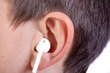 Young caucasian teenage boy's ear and headphone