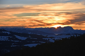 Colorful sunset at a cold winter day at the Saentis mountain in the Swiss Alps