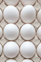 White eggs on white background.
