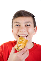 Young caucasian teenage boy with a sausage roll