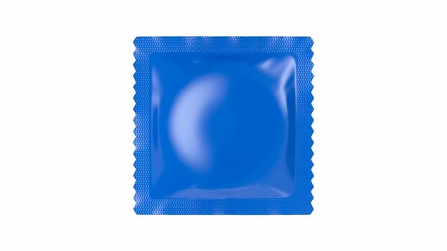 Condom packaging spins on white background