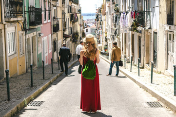 Woman wearing portuguese flag colors in Lisbon, Portugal - obrazy, fototapety, plakaty