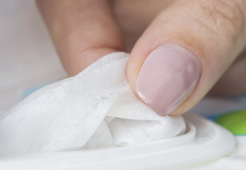 Baby wet wipes in a woman's hand. Close-up, selective focus.