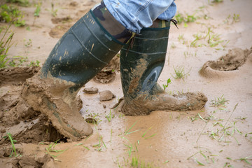 Tourists in rubber boots is on dirt