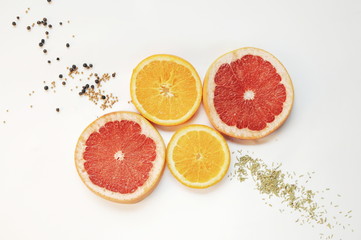 Grapefruits and oranges on white background. Fruits with spices