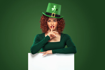 St Patrick Day. Young sexy oktoberfest woman, wearing a dress and green hat with clover, on green...