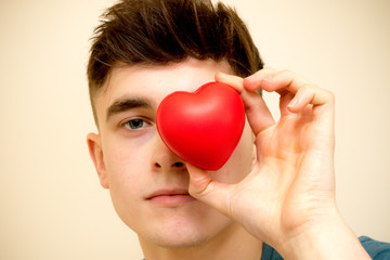 Holding a red heart for love