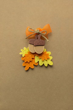 Happy Thanksgiving day / Creative thanksgiving day concept photo of acorns with leaves made of paper on brown background.