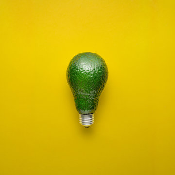 Fresh idea / Creative concept photo of avocado as electric bulb on yellow background.