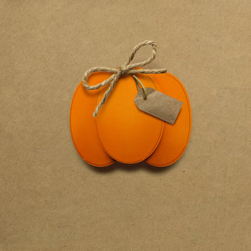 Happy Thanksgiving day / Creative thanksgiving day concept photo of pumpkin made of paper on brown background.