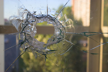 broken glass window reflecting blue sky