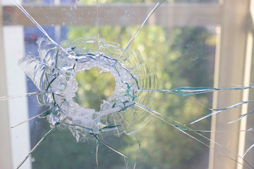 broken glass window reflecting blue sky