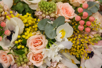 Beautiful designer white yellow pink wedding bouquet of florist with different flowers closeup. Flowers background