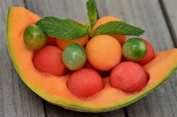 Melon balls on the wooden board