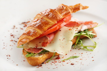 croissant sandwich with ham on white background