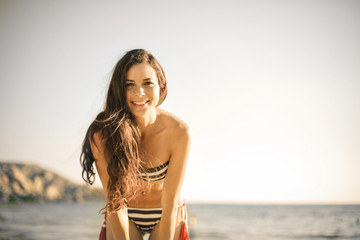 Smiling young woman at the beach