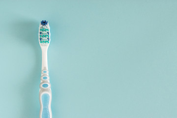 Toothbrush on bright blue background.