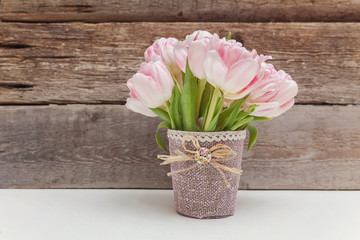 Bouquet of pink tulips on shabby wooden background. Spring greeting card happy mother day copy space