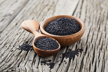 Black cumin on wooden background