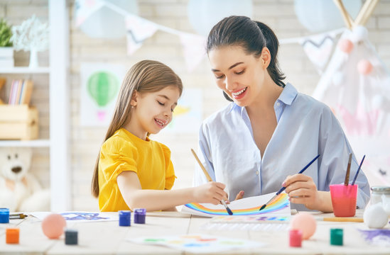 Mother and daughter painting together