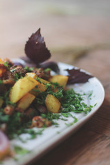 Fried potato with meat and greens