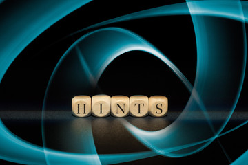 Hints word on wooden cubes. Hints concept