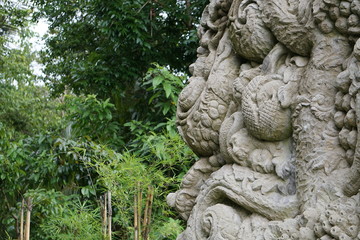 Wall and relief in Bali Indonesia with jungle in the back