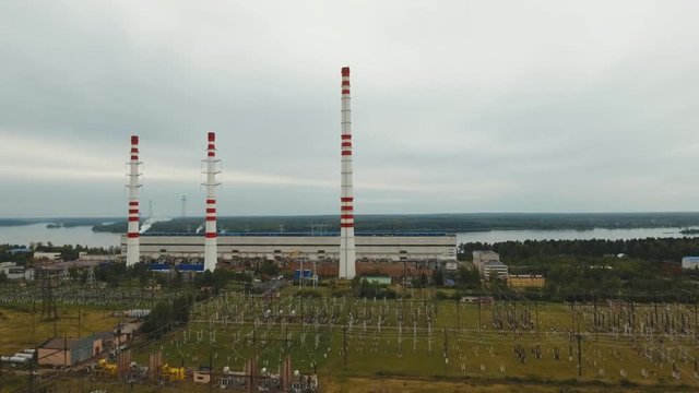 Aerial view Hydroelectric power station, transformation station, cables and wires. High voltage electric power substation. Electrical power transformer in high voltage substation, 4K, aerial footage.