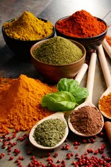 Zelfklevend Fotobehang Variety of spices on kitchen table © monticellllo