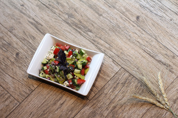 Vegetables salad on a wooden background