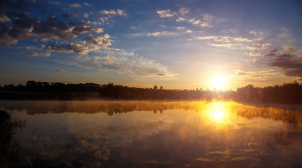 beautiful background of nature. wonderful misty landscape. amazing foggy morning, colorful sky reflected in the water of tranquil lake