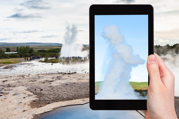 tourist photographs Strokkur geyser eruption