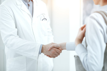 Doctor and patient shaking hands in the office