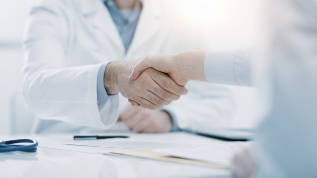 Doctor and patient shaking hands in the office