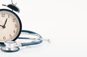Regular or routine medical examination concept, stethoscope and alarm clock on white background - 192713707