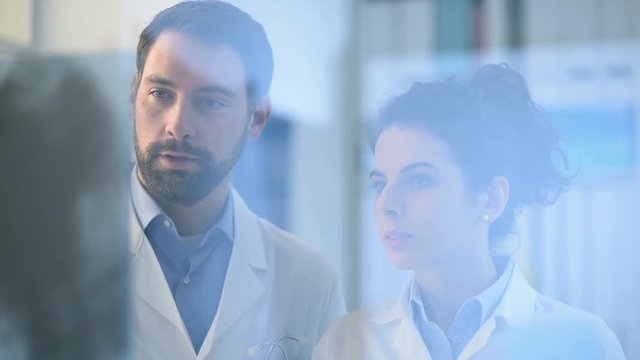 Doctors working together and examining an x-ray