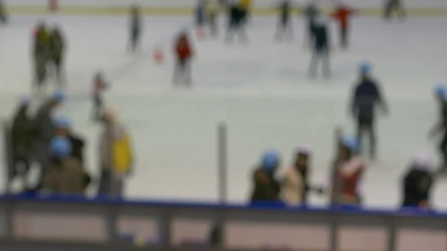 Defocused Unrecognisable Anonymous People Are Skating On Indoor Ice Rink