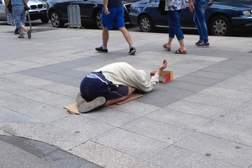 Homeless man begs for money