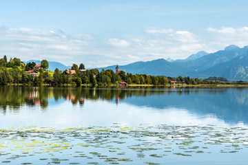 Green water Weissensee lake in Alps Mountains