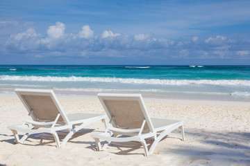 Two white beach chairs on the empty beach , Yucatan, Mexico