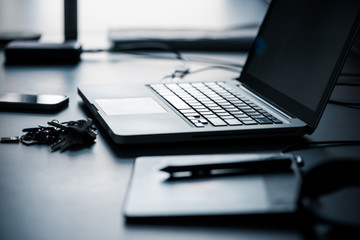 Close up shot of a open laptop and other equipment.