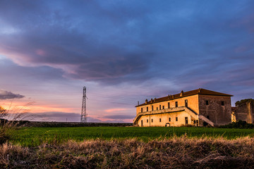 An old farmhouse at sunset