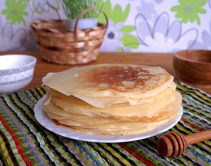 Thin pancakes with sour cream and honey
