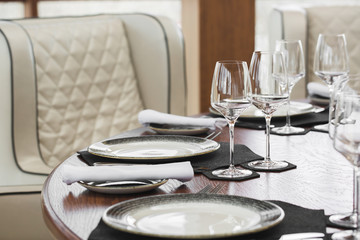 Luxury table set in restaurant, serving classic style dining room interior