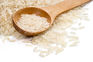 Close up of wooden spoon and parboiled rice scattered on white background. High resolution product. Healthy food concept