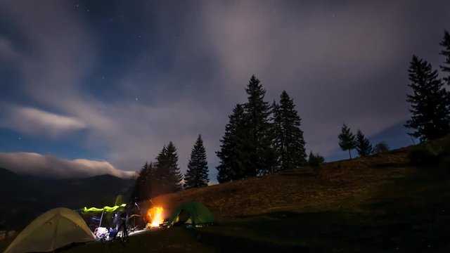 Moving stars above tent at night. Overnight in wild areas.
