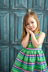 Little girl in green dress and long hair