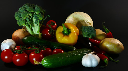 Big set organic food. Fresh raw vegetables. On a black chalkboard.